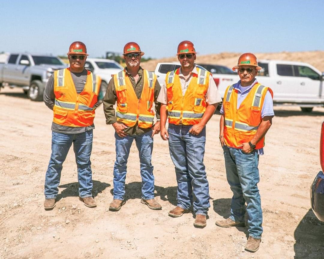 Acadia crew members in safety vests on a job site